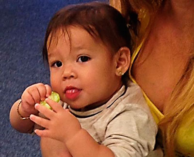 a baby tasting some fruit at Make it Take it